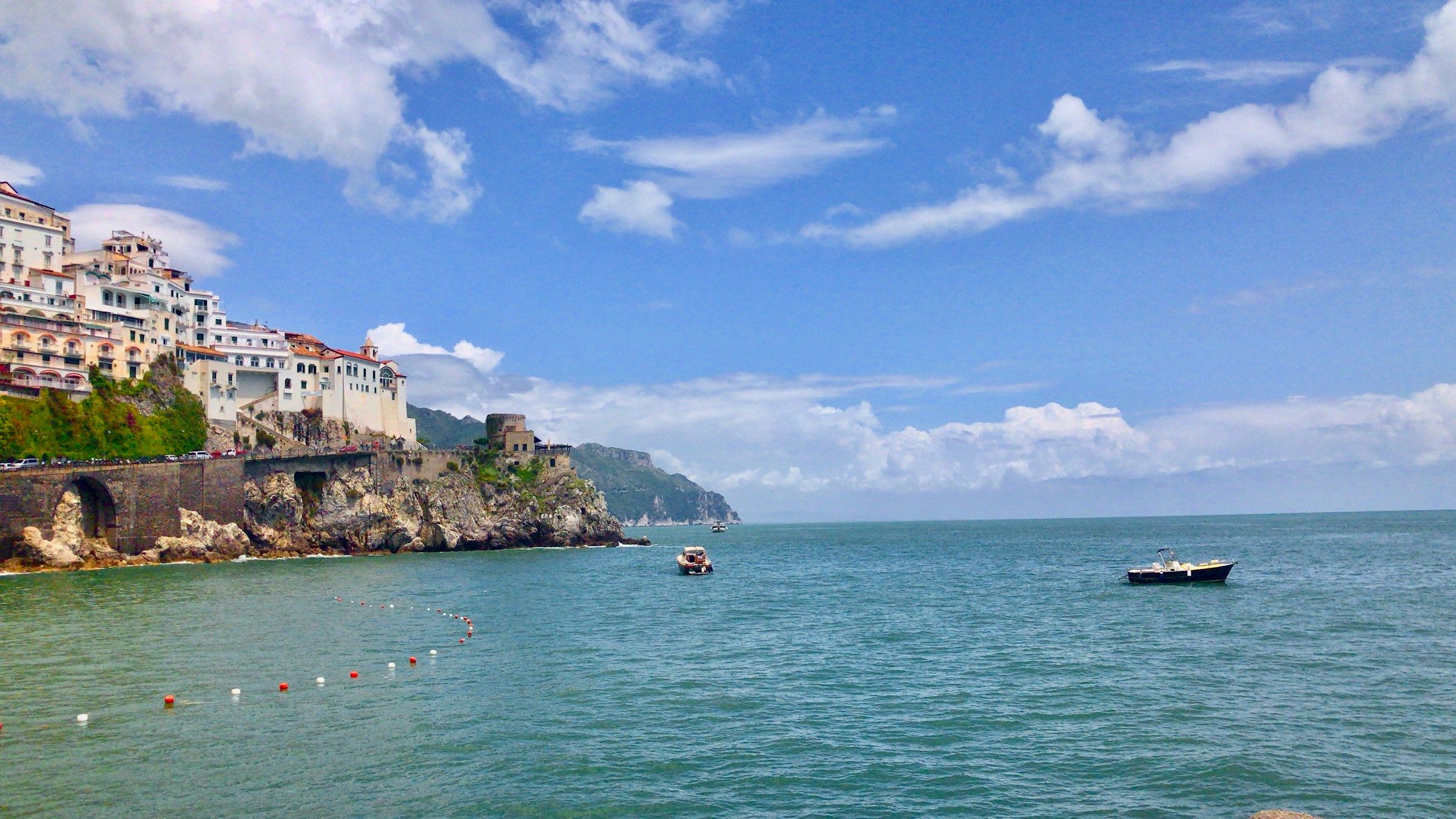 A small boat on the clear water of the Amalfi Coast