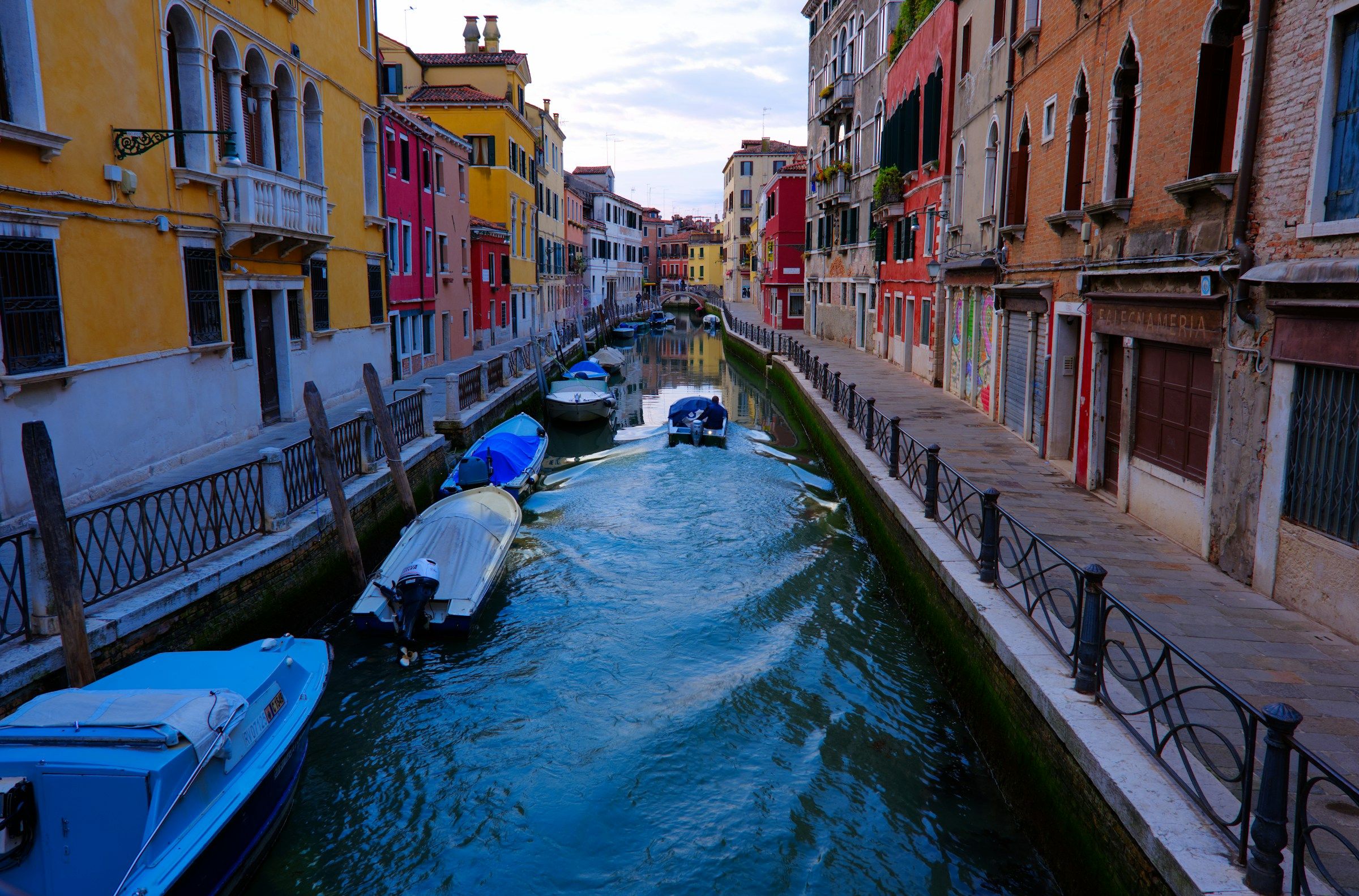 A canal in Venice lined with colourful houses